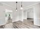 Dining room with wood floor and stylish pendant lights which leads to kitchen at 980 Charter Club, Lawrenceville, GA 30043