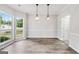 Bright dining room with modern pendant lights and large windows overlooking the front yard at 980 Charter Club, Lawrenceville, GA 30043