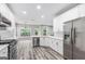 Kitchen with white cabinets, stainless steel appliances, and a modern backsplash at 980 Charter Club, Lawrenceville, GA 30043