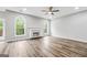 Spacious living room with wood floors, a fireplace, and two large windows for natural light at 980 Charter Club, Lawrenceville, GA 30043