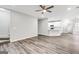 Open-concept living room with wood floors, ceiling fan, and views to the kitchen at 980 Charter Club, Lawrenceville, GA 30043