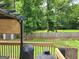 Backyard view from deck, featuring privacy fence, mature trees, and some outdoor storage at 223 Overland Trl, Mcdonough, GA 30252
