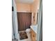 Cozy bathroom featuring a shower with curtain, toilet, and vanity with storage at 223 Overland Trl, Mcdonough, GA 30252