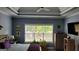 Spacious bedroom offers natural light, gray walls, wood furniture, and cozy decor at 223 Overland Trl, Mcdonough, GA 30252