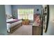 Comfortable bedroom features carpet, window, and wood furnishings at 223 Overland Trl, Mcdonough, GA 30252
