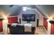 Bonus room or converted attic space, set up as home theater, with comfortable seating and TV at 223 Overland Trl, Mcdonough, GA 30252