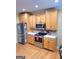 Bright kitchen featuring stainless steel appliances, ample cabinetry, and hardwood floors at 223 Overland Trl, Mcdonough, GA 30252