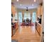 Well-lit kitchen featuring stainless steel appliances, light wood cabinets, hardwood floors, and eat-in dining area at 223 Overland Trl, Mcdonough, GA 30252