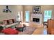 Inviting living room featuring hardwood floors, a fireplace, comfortable seating, and natural light at 223 Overland Trl, Mcdonough, GA 30252