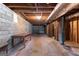 Unfinished basement with concrete floor, cinder block walls, and exposed wood rafters; ready for your personal design at 115 Fernway Dr, Fayetteville, GA 30214