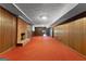 Finished basement featuring red carpet, paneled walls, brick fireplace and window at 115 Fernway Dr, Fayetteville, GA 30214
