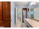Bright bathroom with tile floor, granite vanity and doorway to toilet and shower area at 115 Fernway Dr, Fayetteville, GA 30214