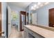 Bathroom with a granite vanity and tile floor with doorway to the toilet and shower at 115 Fernway Dr, Fayetteville, GA 30214