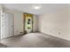 Well-lit bedroom with neutral carpet and a window looking out onto a green yard at 115 Fernway Dr, Fayetteville, GA 30214