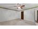 Spacious bedroom featuring neutral carpet, a ceiling fan, and fresh paint at 115 Fernway Dr, Fayetteville, GA 30214