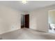 Neutral bedroom featuring carpet, white walls, and doorways to other rooms at 115 Fernway Dr, Fayetteville, GA 30214
