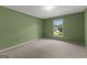 Green bedroom with plush carpeting and a window view of the outdoors at 115 Fernway Dr, Fayetteville, GA 30214