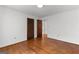 Spacious bedroom with hardwood floors, closet, and doorways to other rooms at 115 Fernway Dr, Fayetteville, GA 30214