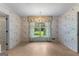 Charming dining room with floral wallpaper, chandelier, and lots of natural light at 115 Fernway Dr, Fayetteville, GA 30214