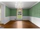 Elegant dining room with hardwood floors, chandelier, and a window with a view at 115 Fernway Dr, Fayetteville, GA 30214