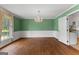 Elegant dining room featuring hardwood floors, decorative wallpaper, and chandelier at 115 Fernway Dr, Fayetteville, GA 30214