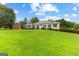 Expansive front yard view of this classic home's brick exterior and manicured landscaping at 115 Fernway Dr, Fayetteville, GA 30214