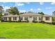 Charming single-story home with a well-maintained lawn and classic architectural details at 115 Fernway Dr, Fayetteville, GA 30214