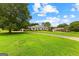 Sprawling lawn and circular driveway lead to this lovely home and detached garage at 115 Fernway Dr, Fayetteville, GA 30214