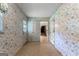 Hallway with decorative wallpaper, tile flooring, and view of adjoining rooms at 115 Fernway Dr, Fayetteville, GA 30214