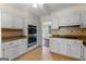Spacious kitchen with stainless steel appliances, tiled backsplash, and an open layout at 115 Fernway Dr, Fayetteville, GA 30214