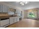 Kitchen featuring tiled floors, granite counters, and stainless steel appliances at 115 Fernway Dr, Fayetteville, GA 30214