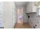 Functional laundry room with storage cabinets and tile flooring at 115 Fernway Dr, Fayetteville, GA 30214