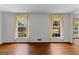 Bright Living Room features hardwood floors, two large windows and adjoining room at 115 Fernway Dr, Fayetteville, GA 30214