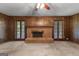 Living room with fireplace and wooden paneled walls and carpeted flooring at 115 Fernway Dr, Fayetteville, GA 30214