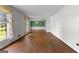 Bright and airy living room with hardwood floors and large windows with decorative curtains at 115 Fernway Dr, Fayetteville, GA 30214