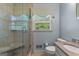Tile shower with frameless glass door, integrated seat, and a window bringing in natural light at 115 Fernway Dr, Fayetteville, GA 30214