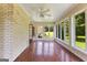 Bright sunroom with brick accent wall, tile flooring, and backyard views at 115 Fernway Dr, Fayetteville, GA 30214