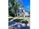Exterior shot of a charming two-story home with white siding, a cozy front porch, and green surroundings at 1225 Bridges Sw Ave, Atlanta, GA 30310