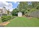 A large, well-maintained backyard includes a small storage shed, a lawn and wooden fencing at 332 Aster Ridge Trl, Peachtree City, GA 30269