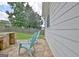 A backyard patio with chairs and a built-in grill, with grassy areas beyond the fenced yard at 332 Aster Ridge Trl, Peachtree City, GA 30269