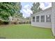 Spacious backyard with a well maintained lawn and rear sunroom at 332 Aster Ridge Trl, Peachtree City, GA 30269