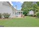 The backyard has a manicured lawn, shed, and a stone patio with seating at 332 Aster Ridge Trl, Peachtree City, GA 30269