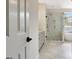 Bright, tiled bathroom features a sleek glass shower with a niche and a soaking tub under a window at 332 Aster Ridge Trl, Peachtree City, GA 30269