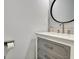 Close up view of stylish powder room with grey vanity, white countertop and round mirror at 332 Aster Ridge Trl, Peachtree City, GA 30269