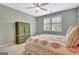 Bedroom with ceiling fan, hardwood flooring, and patterned bedding at 332 Aster Ridge Trl, Peachtree City, GA 30269