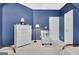Blue bedroom with white dresser and accent chair at 332 Aster Ridge Trl, Peachtree City, GA 30269