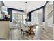 Chic dining room with hardwood floors, wainscoting, modern lighting, and ample natural light at 332 Aster Ridge Trl, Peachtree City, GA 30269