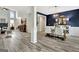 Elegant dining room with hardwood floors, stylish lighting, and an open view of the living area at 332 Aster Ridge Trl, Peachtree City, GA 30269