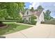 Long driveway leads to a well-maintained home with manicured landscaping and mature trees at 332 Aster Ridge Trl, Peachtree City, GA 30269