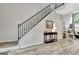 Welcoming foyer with staircase, artwork, and hardwood floors leading to the living area at 332 Aster Ridge Trl, Peachtree City, GA 30269